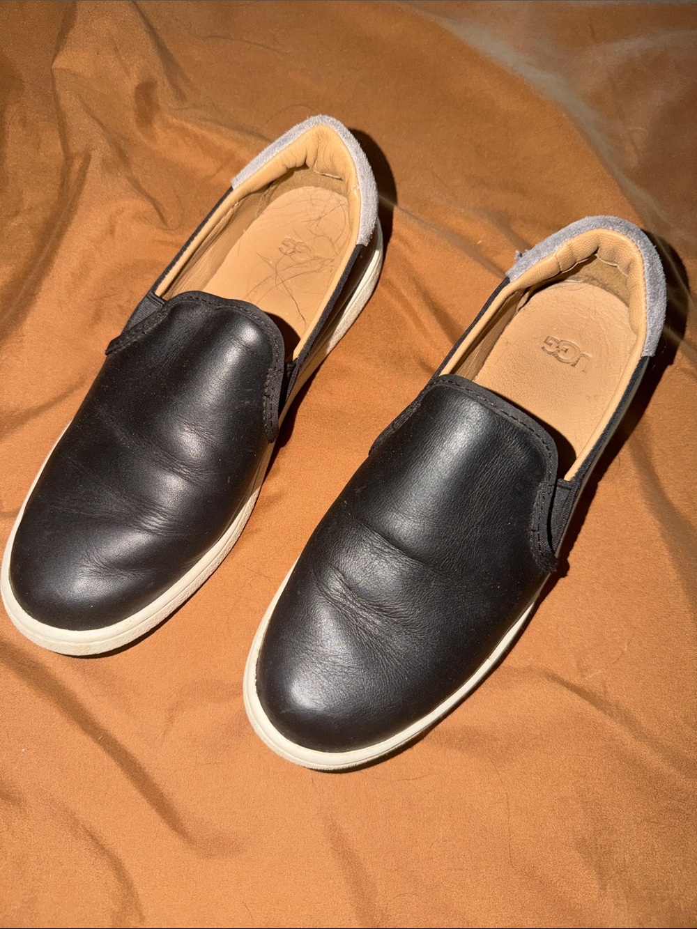 UGG women’s Black Slip-On Leather Sneakers